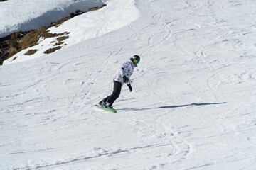 man snowboarding on the mountain on a sunny day