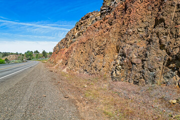 Rocky cliffs line the edge of Highway 26 near Dayville, Oregon, USA