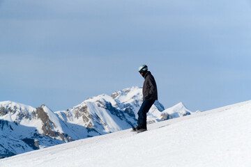man snowboarding on the mountain on a sunny day