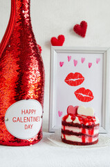 Happy Galentine`s day greeting banner. A bottle of vine, a sweet dessert, a garland of red felt hearts and frame with traces of a woman's kiss.