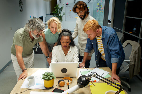 Diverse Team of Professional Business people Meeting in the Office Conference Room. Creative Team Around Table, colleagues Speak for Marketing Campaign, Social Media Strategy. Modern Workplace