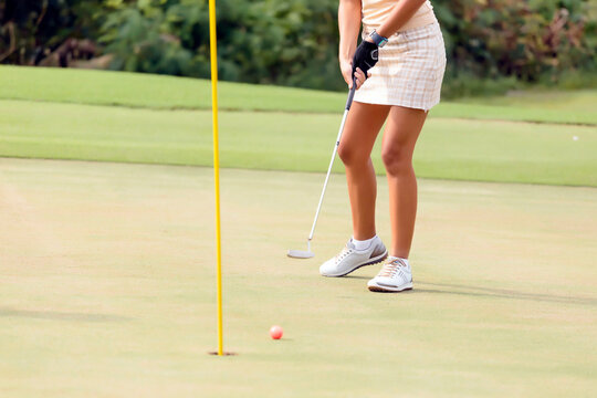 Low section of woman playing golf at golf course