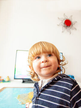 Gaspard a little boy having a smile in his home, Lomener, Brittany, France.