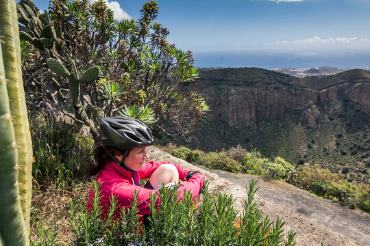 Tired Mountain Biker Looking At Distance