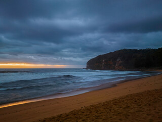 Sunrise over the ocean with rain clouds