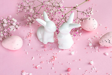 Easter background. Easter bunnies on a pink background. happy easter card. Easter. Flowers