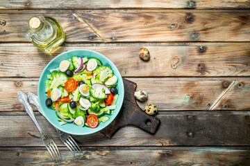 Vegetable salad. Tomato, cucumber and quail egg salad with olive oil and Basil.