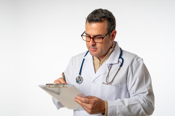 medical man on a white background with gown and stethoscope writing in a folder