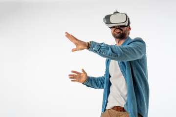 young handsome man with virtual reality goggles on white background. copy space