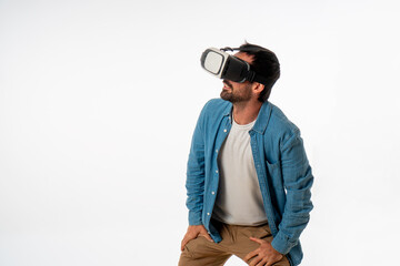 young handsome man with virtual reality goggles on white background. studio photo