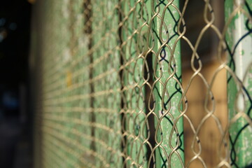 Chain link fence in sunset around the ballet school in Tirana, Albania