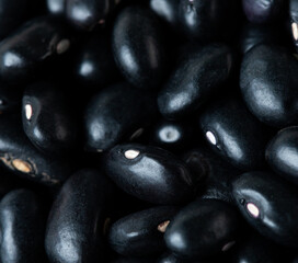 Macro Close up Texture of black bean, round grain beans. Beautiful complete seed pea bean, food object design. Selective focus freeze shot black background isolated