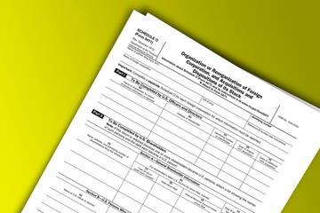Obraz premium Form 5471 (Schedule O) documentation published IRS USA 12.21.2012. American tax document on colored