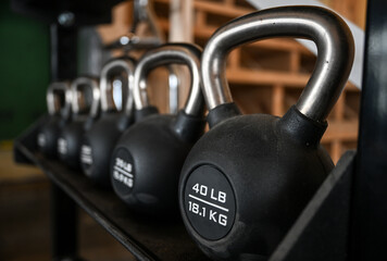 Naklejka na ściany i meble kettlebells lined up at gym with defocused background