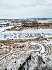 Aerial vertical image of a Frozen and snow covered lake in a city park