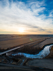 Aerial Vertical Image of a Frozen River and Farmland at Sunset