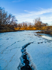 Vertical Image of a frozen snowy river 