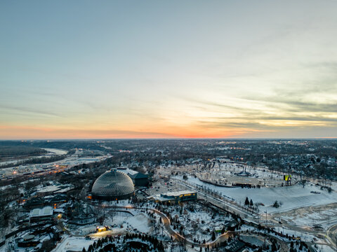 Vertical Aerial image of the Henry Doorly Zoo and Aquarium Omaha Nebraska Zoo Futuristic dome in the winter covered in snow at sunset