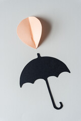 pink paper leaf or tear drop and black paper umbrella glyph cutout