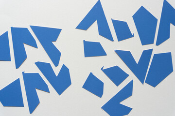 cut blue shapes on blank paper