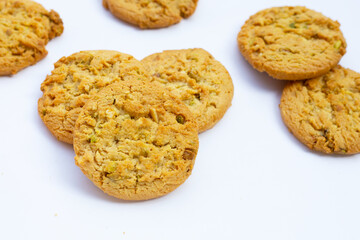 Pistachio and almond cookies on white background.