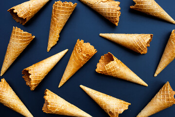 Empty ice cream cone on dark background.