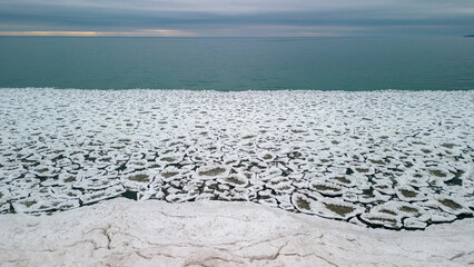 Aerial view of the coast of Lake Ontario in Pickering Ontario featuring interlocking ice chunks