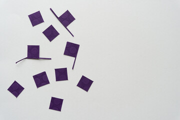 purple paper squares with some texture on blank paper