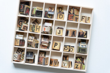 wood box with chipboard tiles showing retro type faces
