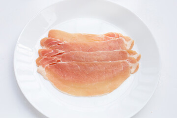 Sliced raw pork meat on white background.