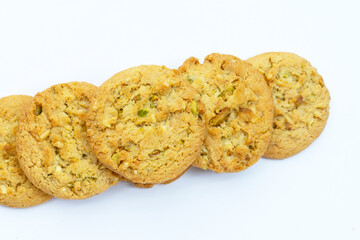 pistachio and almond cookies on white background.