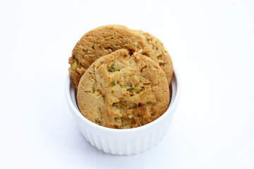 pistachio and almond cookies on white background.