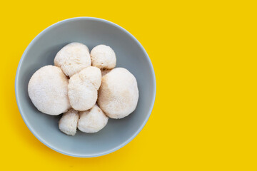 Fresh lion's mane mushroom on yellow background.