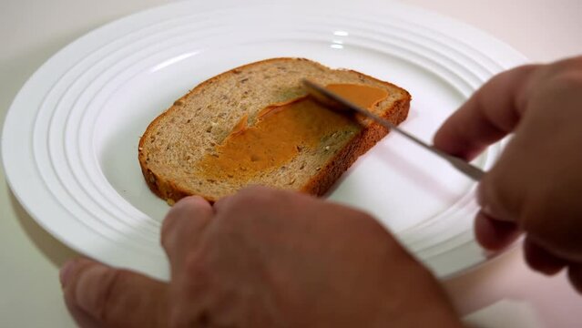 Covering bread with peanuts butter