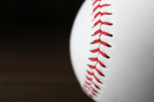 Closeup view of baseball ball on dark background, space for text. Sportive equipment