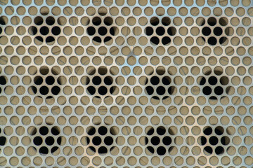 Metal grate with geometric round holes in circular grid pattern for design or texture purposes