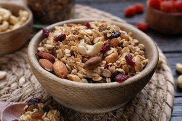 Tasty granola with nuts and dry fruits on wooden table, closeup