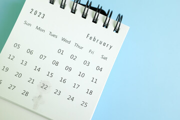 Selective focus of desk calendar with marked February 22 2023. Ash Wednesday date schedule concept.