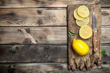 Sliced lemon on a cutting Board with a knife.