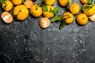 Whole and slices of mandarins with foliage.