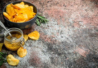 Potato chips with French mustard and rosemary.