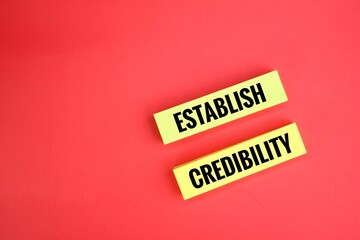 yellow paper with the words ESTABLISH CREDIBILITY. the concept of credibility