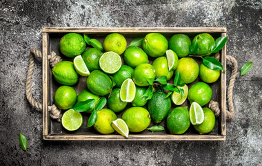 Fresh lime and slices of ripe lime on tray.