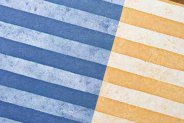Fototapeta na wymiar scrapbook paper with wide stripes in blue and orange yellow