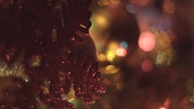 Macro shot of  glowing Christmas ornaments on a tree