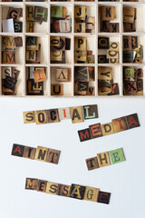 social media aint the message chipboard tiles displaying vintage style letters
