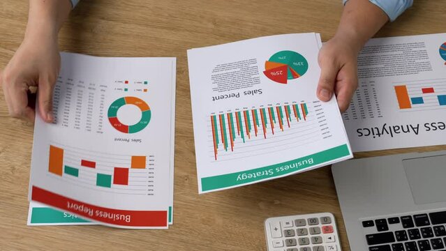 Investors are calculating profits and costs with calculators, growth and investment chart analysis, business planning and strategies to maximize sales profits. Long term business plan.