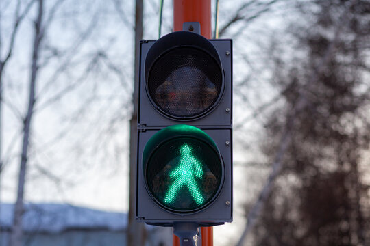 Green light on a pedestrian traffic light. Safe crossing of the road by pedestrians. 