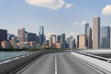 Empty urban asphalt road exterior with city buildings background. New modern highway concrete construction. Concept of way to success. Transportation logistic industry fast delivery. Chicago. USA.