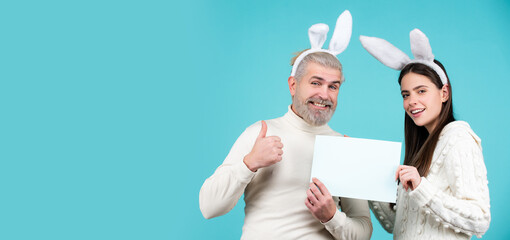 Happy Easter couple. Funny picture of funny couple with rabbit ears. Isolated, text, background and copy space. Panoramic web banner frame.